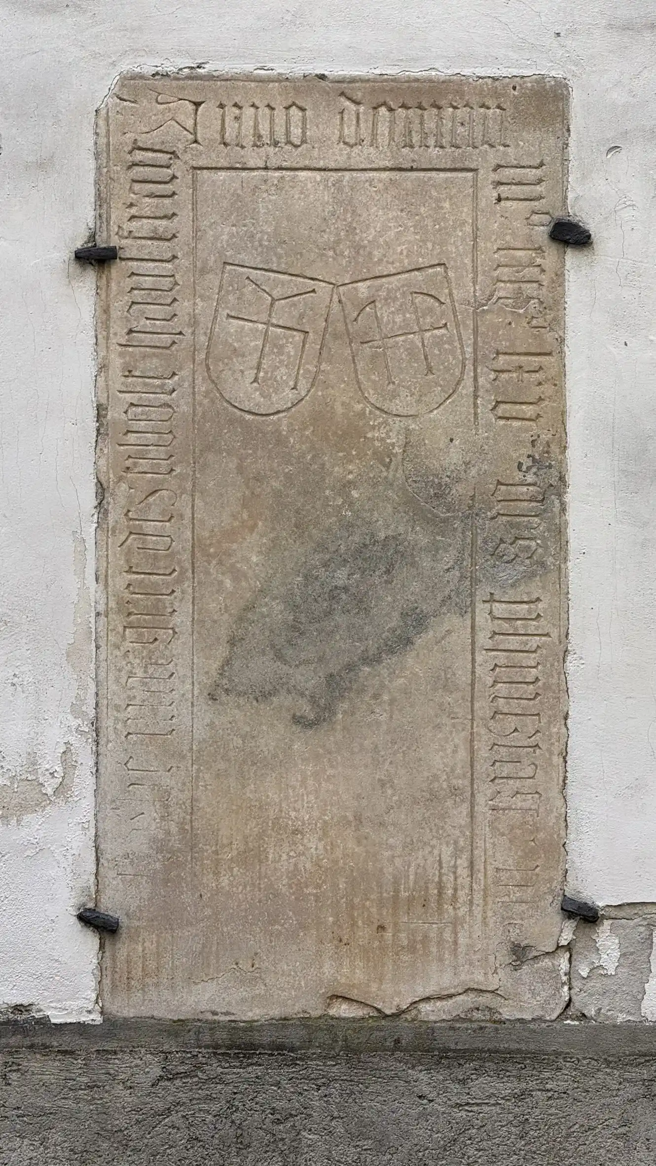 Tombstone embedded in the facade