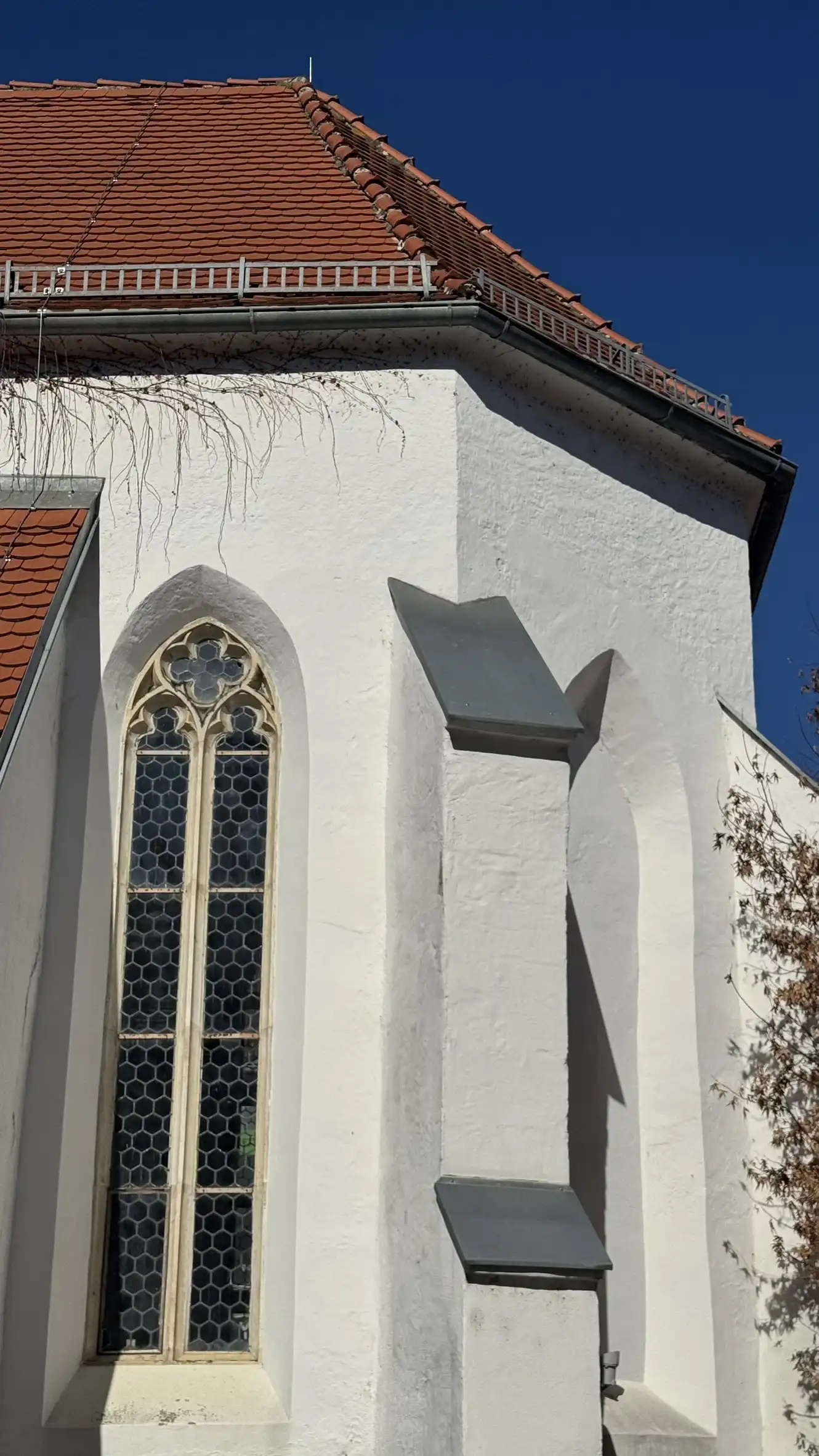 Stepped buttress and Gothic window with tracery