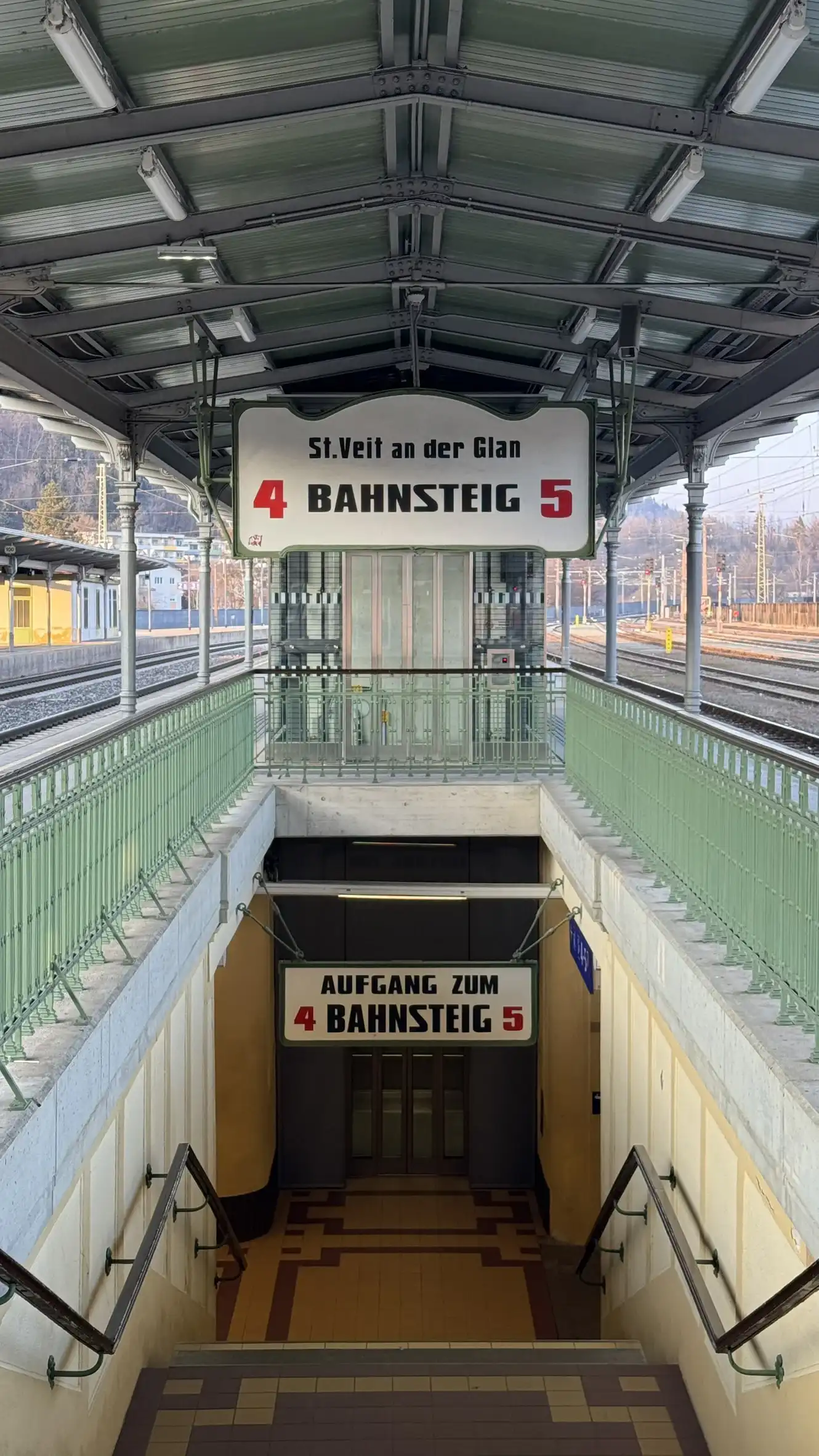 Metal roof frame, support columns, railing, and vintage signs for platform faces 4 and 5