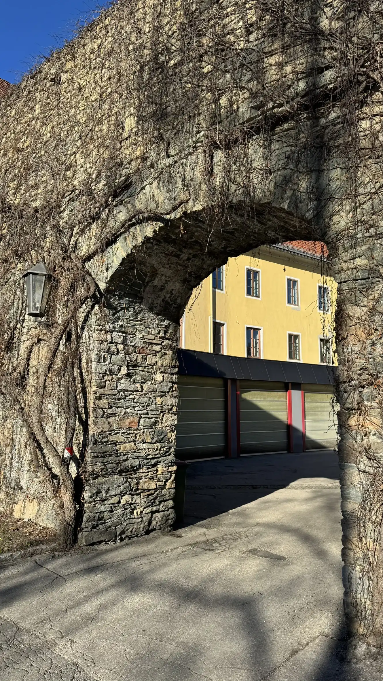 Former fire station seen through the access gate, created in the 20th century
