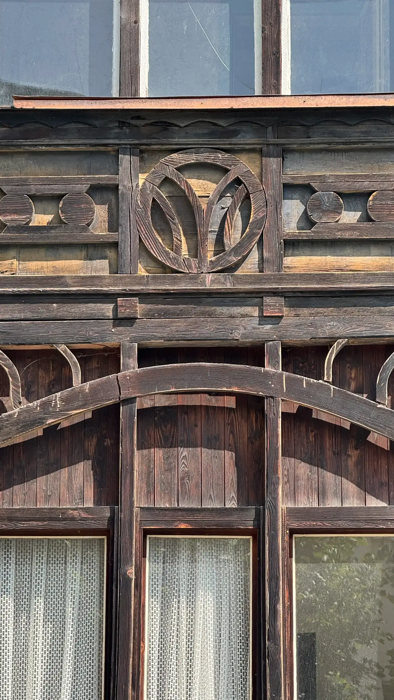 Arched timber brace providing structural support and rhythm