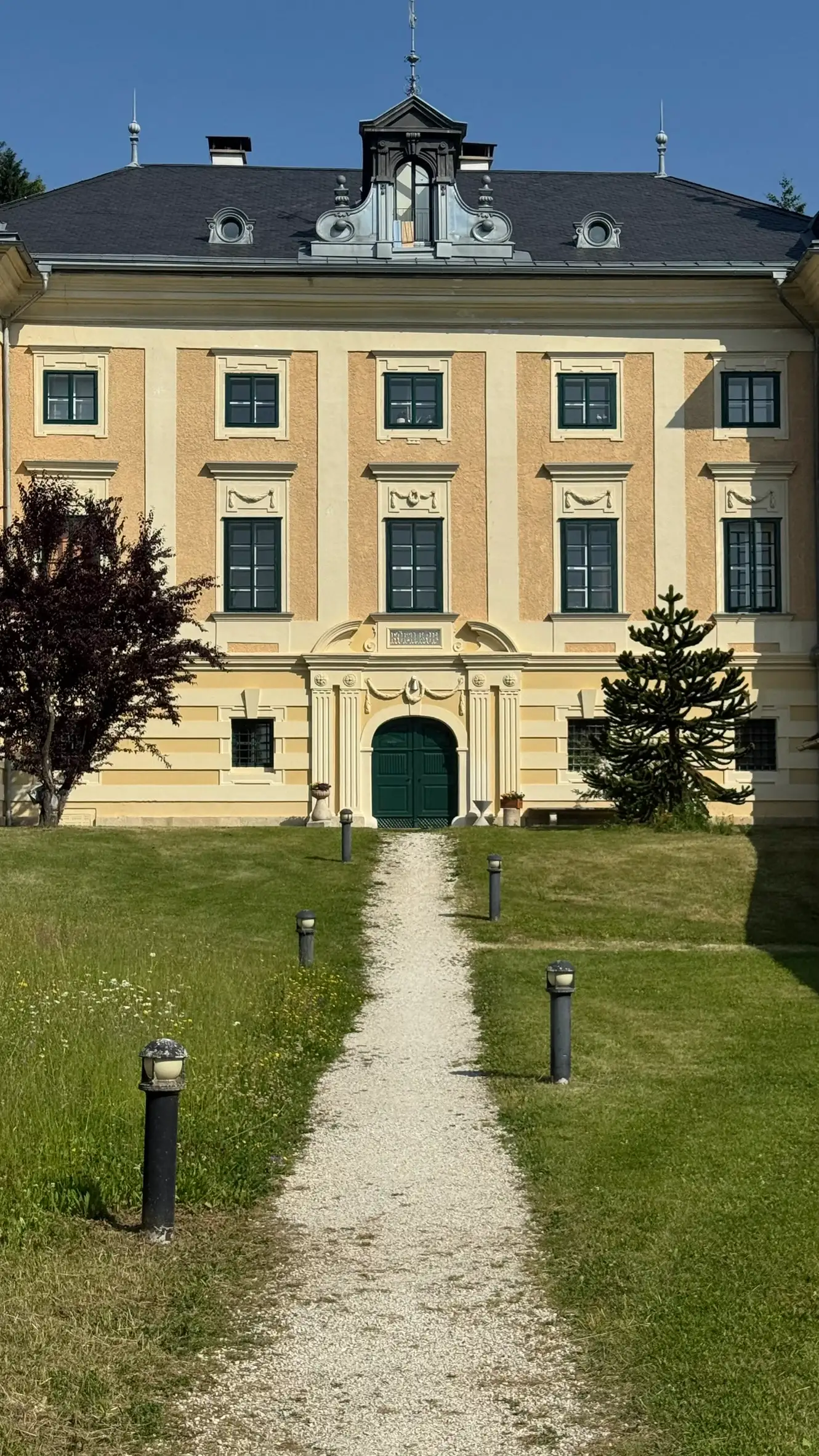 The walls are painted in a warm ochre yellow, with contrasting white plaster detailing.
