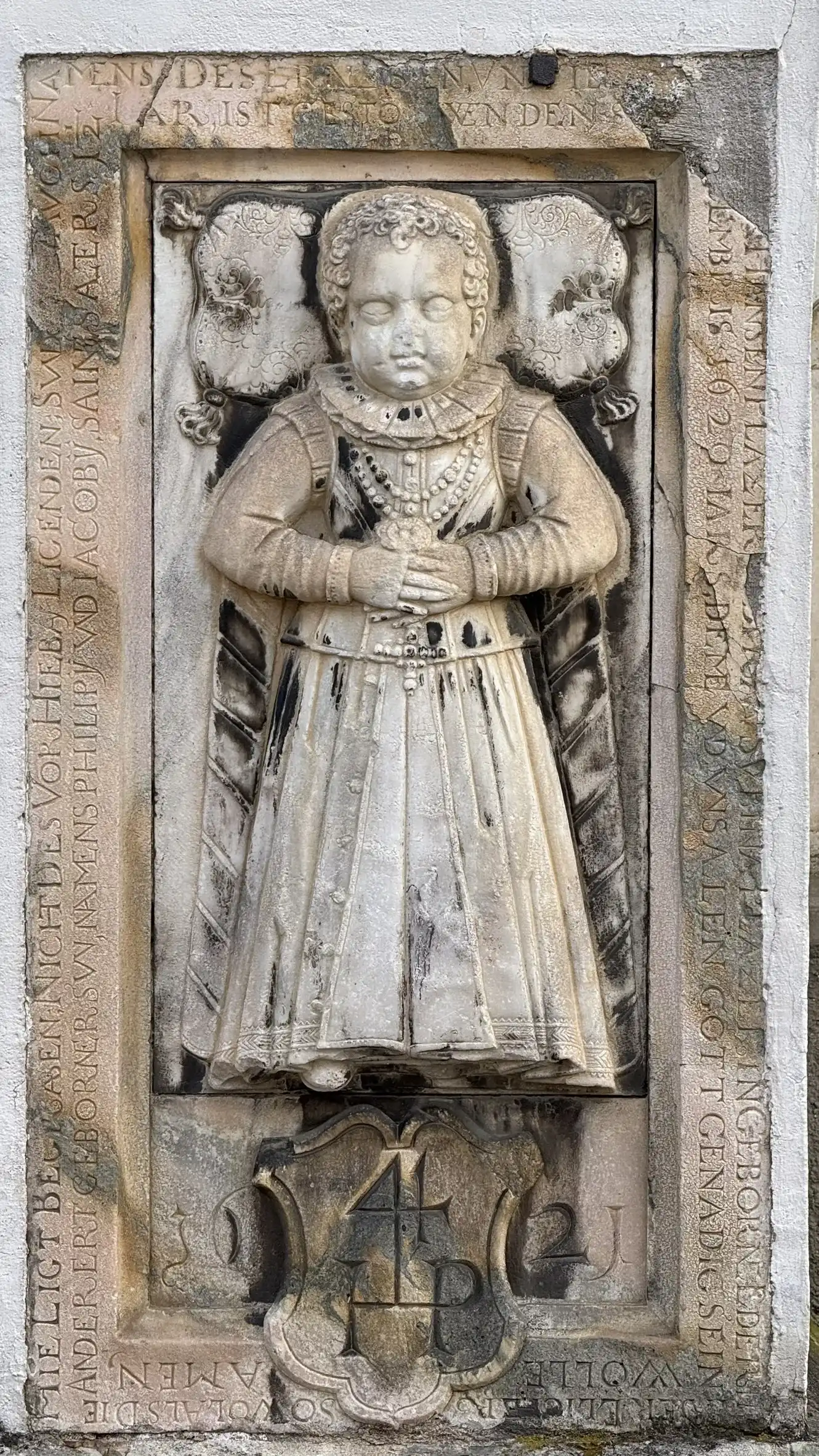 Tombstone embedded in the facade