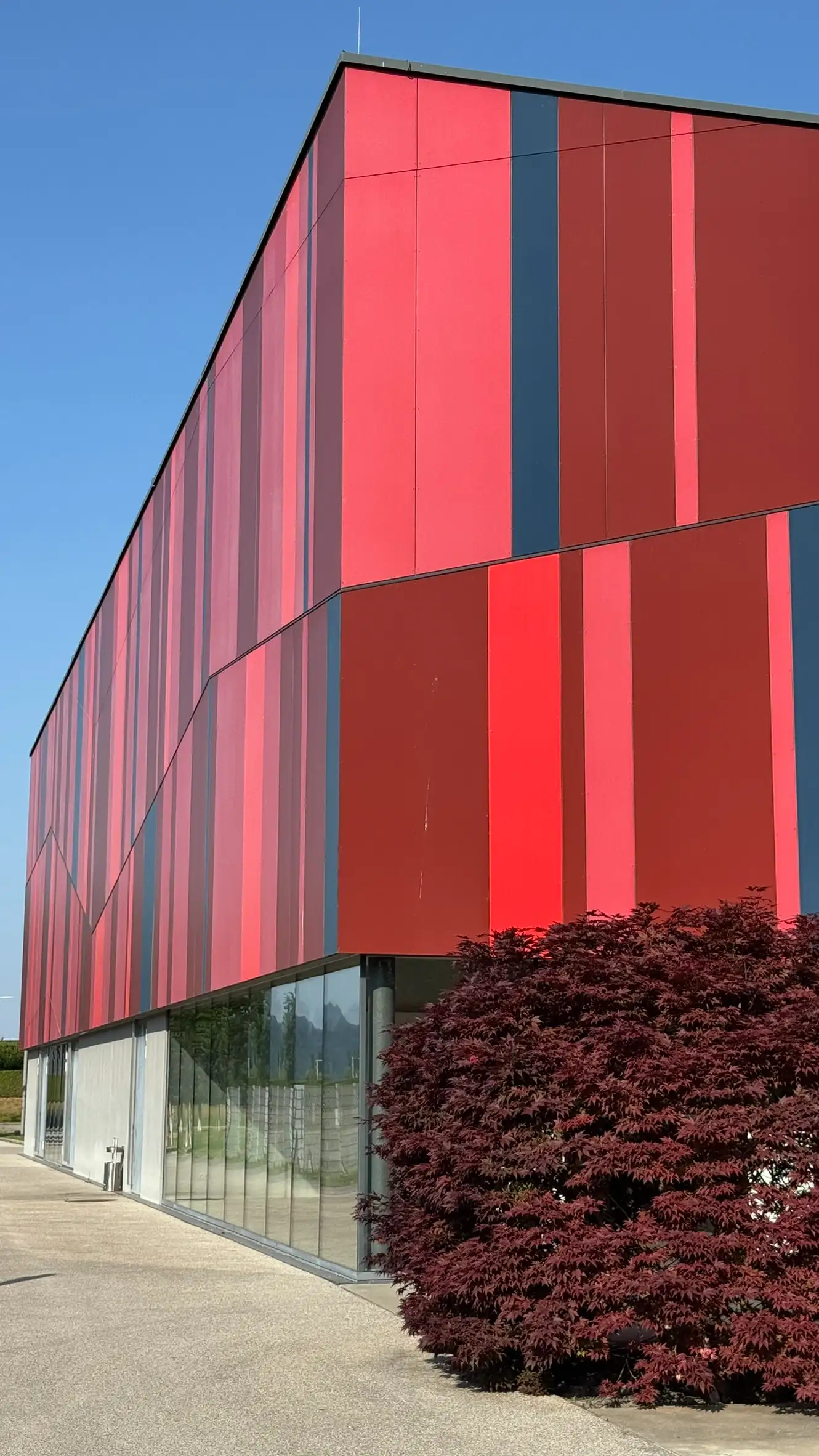 The building's most distinctive feature is its facade, clad in vertical stripes.