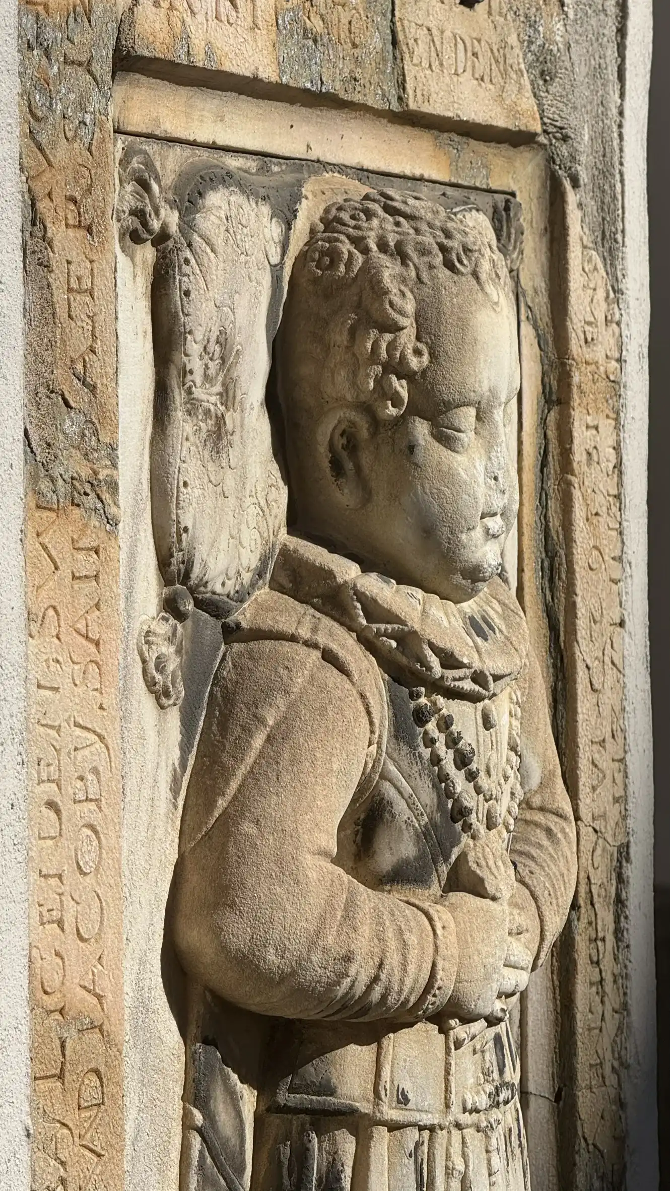 Tombstone embedded in the facade