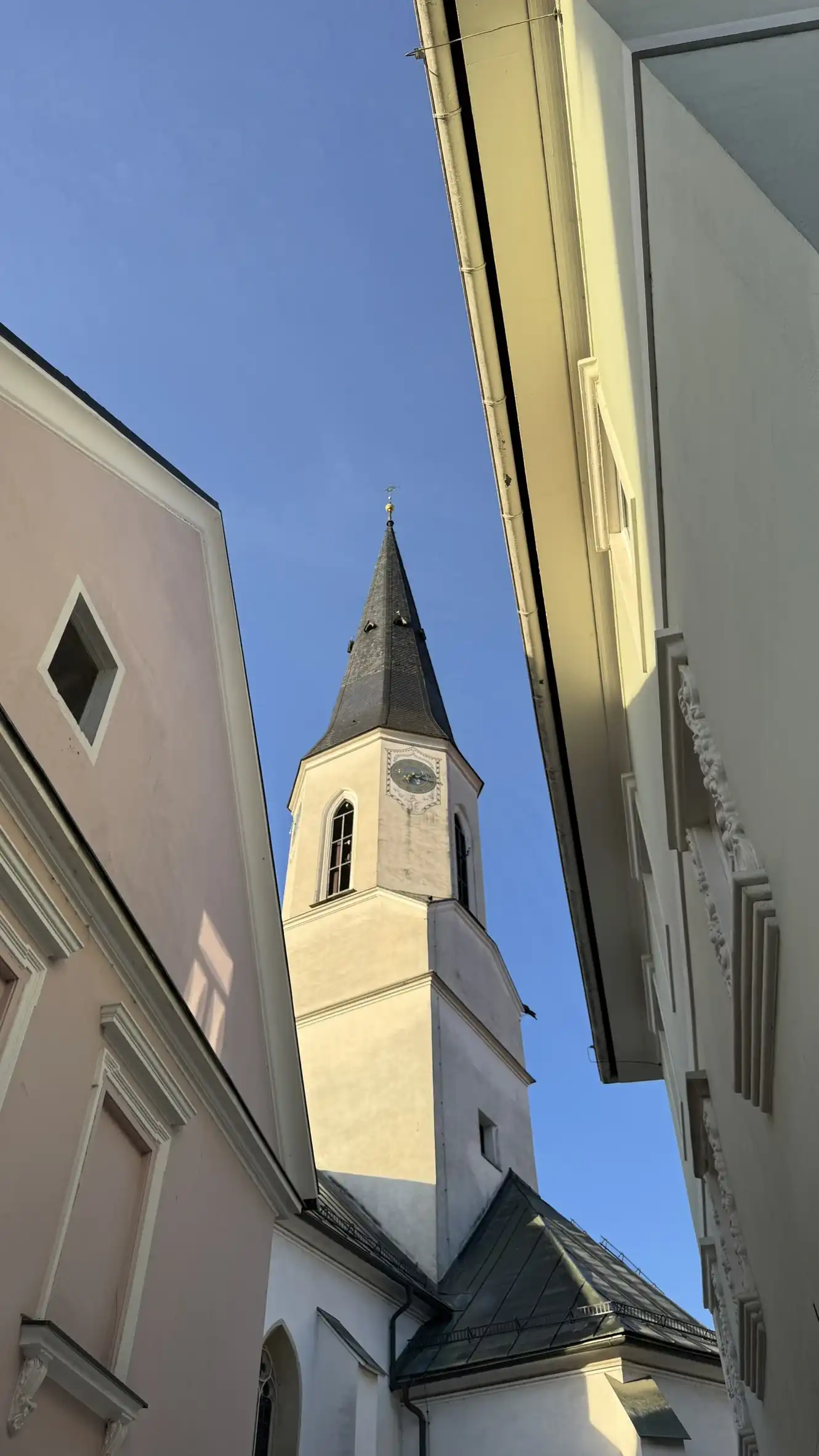 Church tower illuminated by early morning light