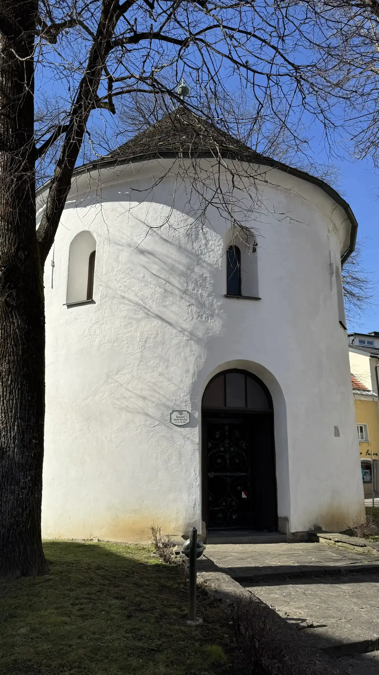 Round-arched entrance with three recessed windows visible
