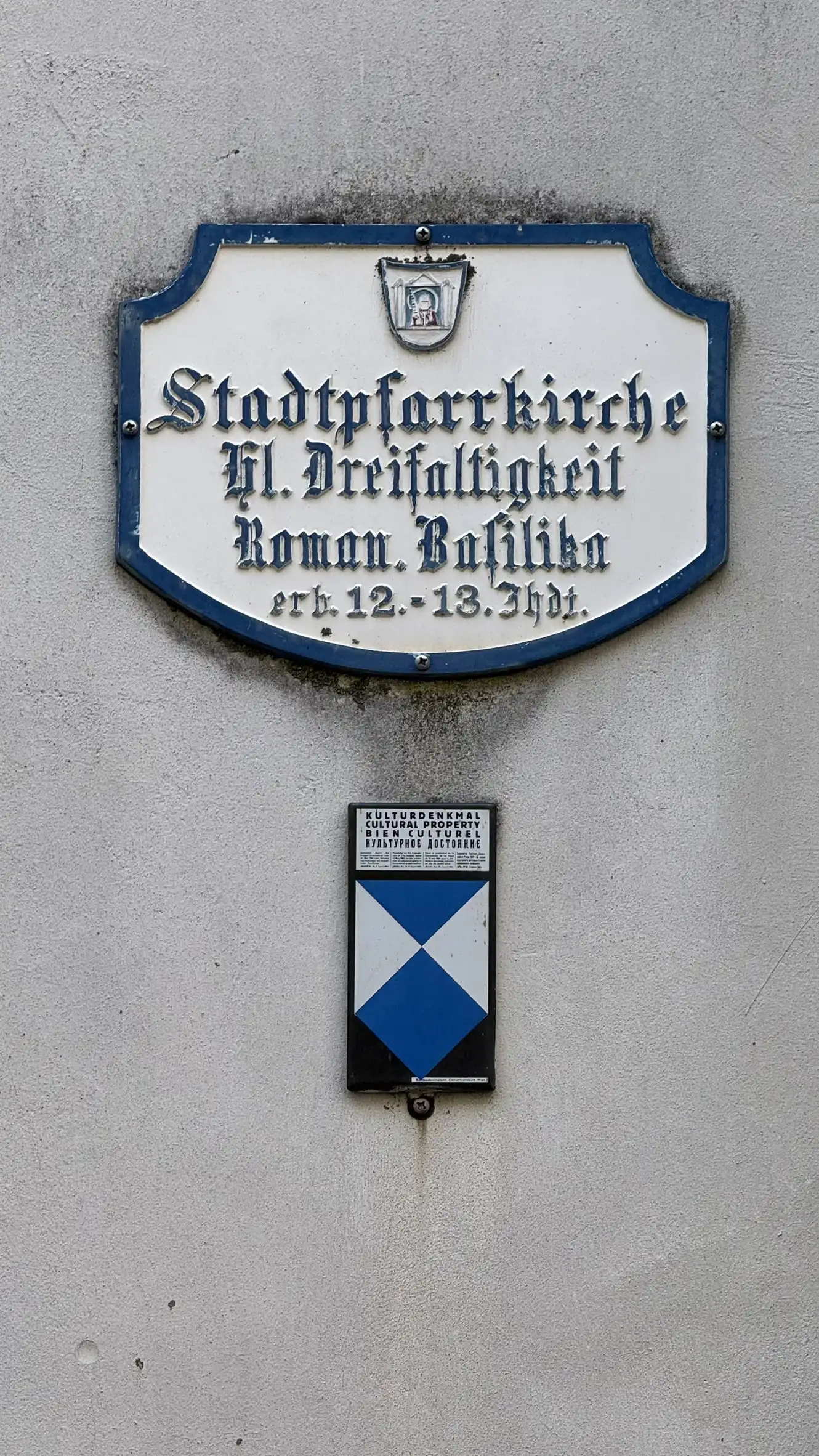 Signage: Parish church dedicated to the Holy Trinity; Romanesque Basilica; built in the 12th–13th century
