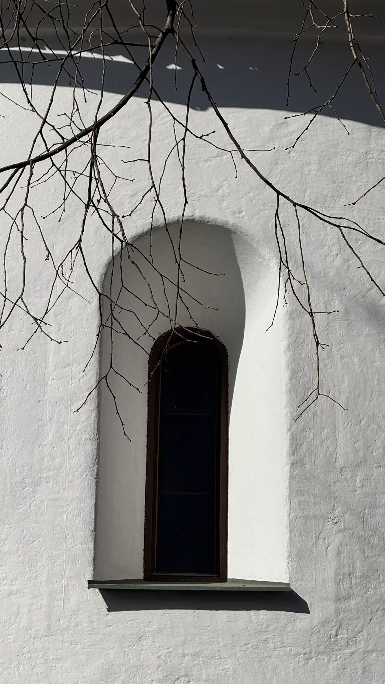 Close-up of recessed round-arched window