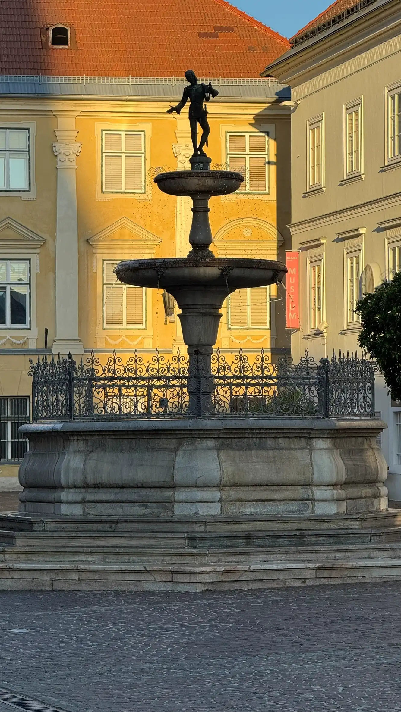 Silhouetted fountain with Palais Koller backdrop