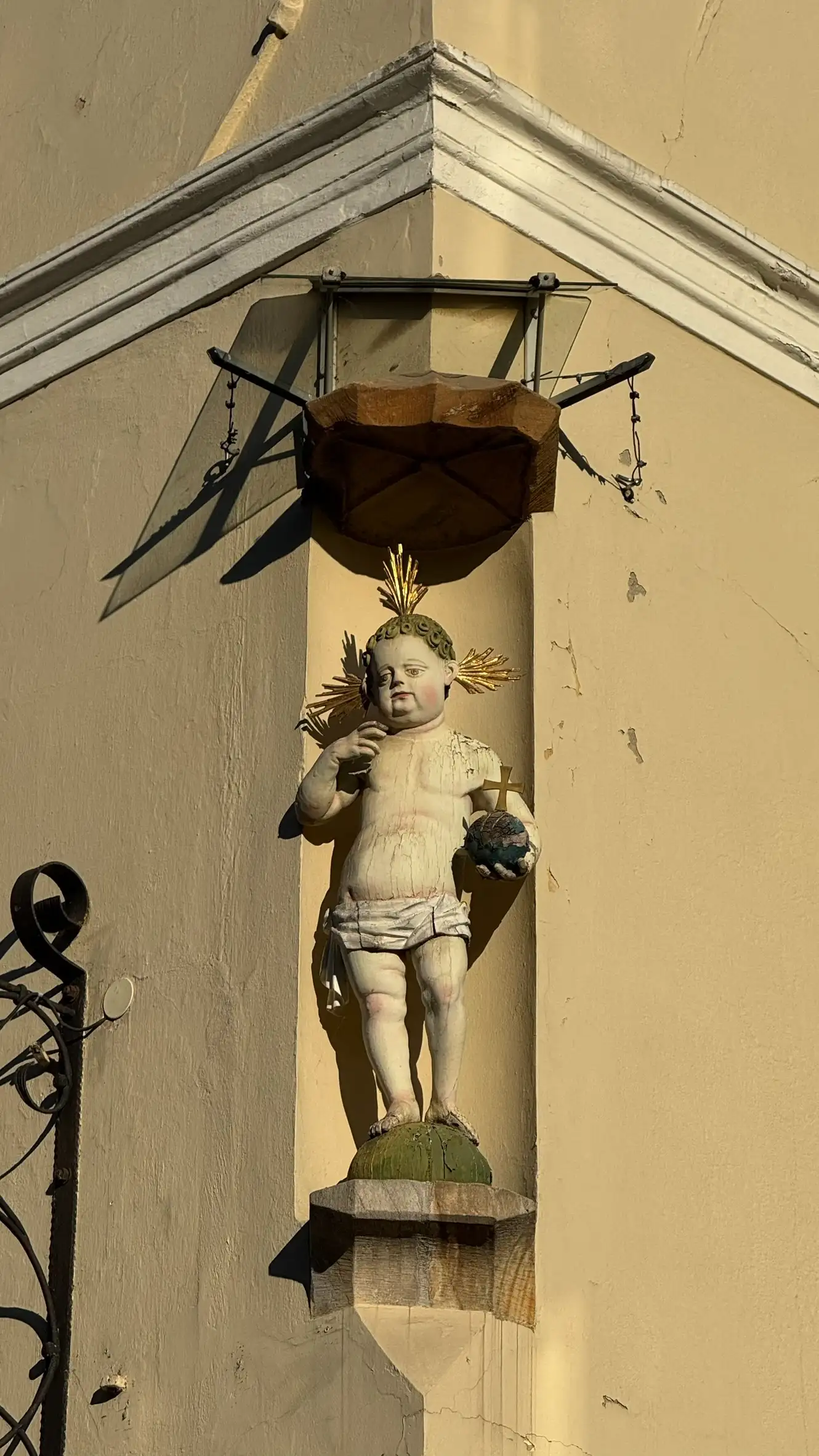 Infant Jesus is positioned beneath a Gothic stone canopy.
