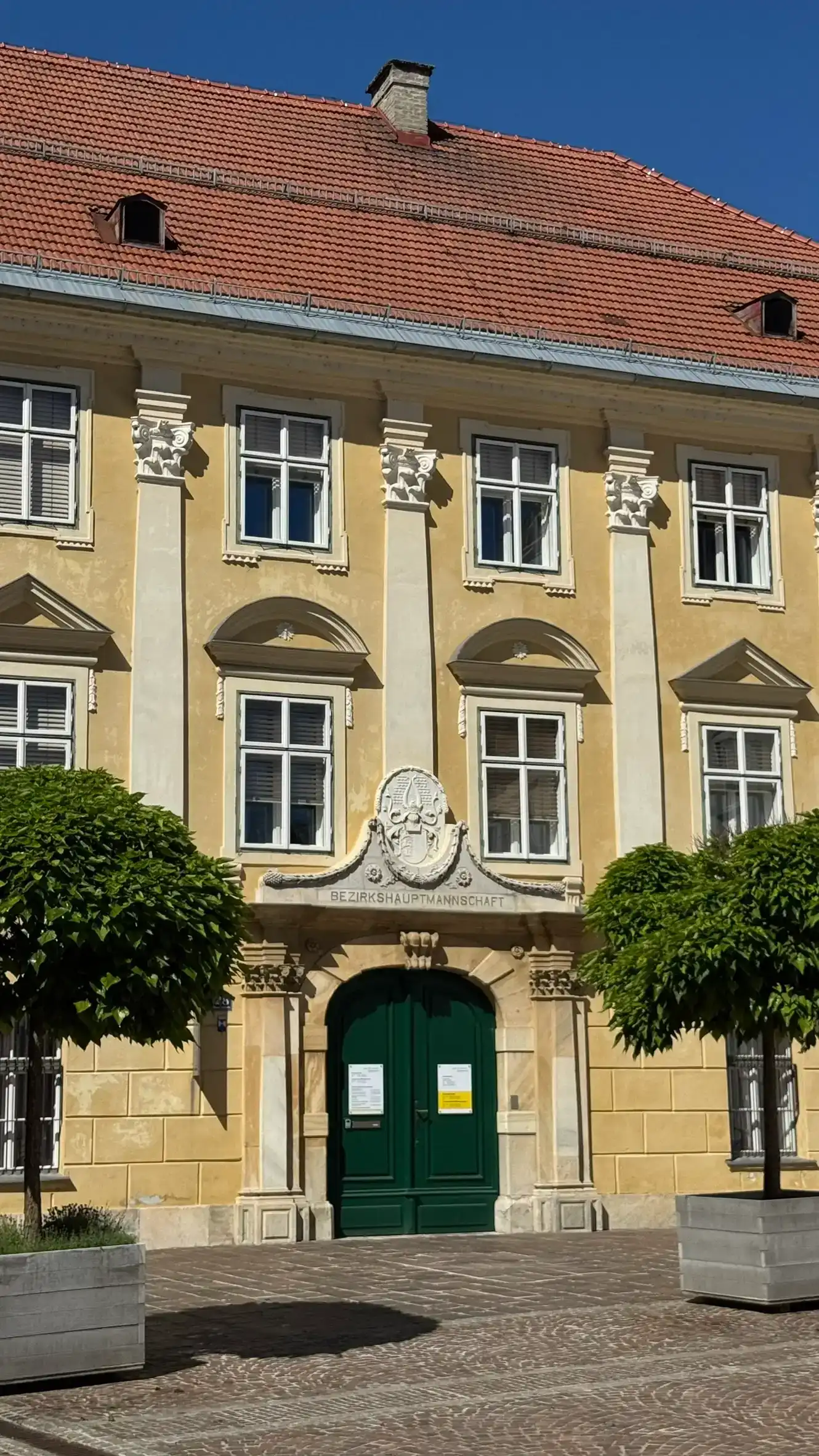 The building features a Neoclassical pilaster facade.