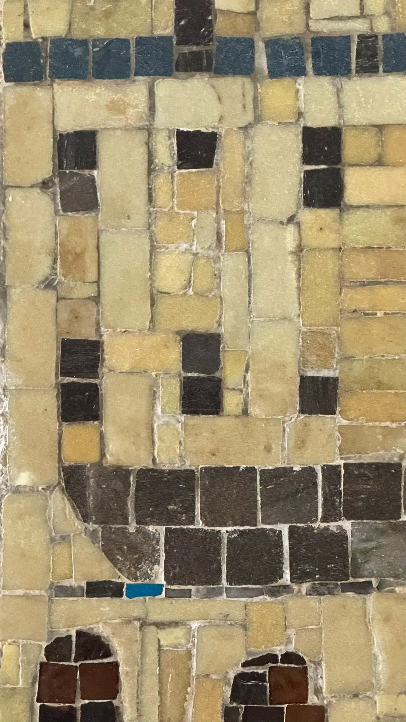 Tesserae colours: pale brown, warm yellow, teal blue, coffee brown, black