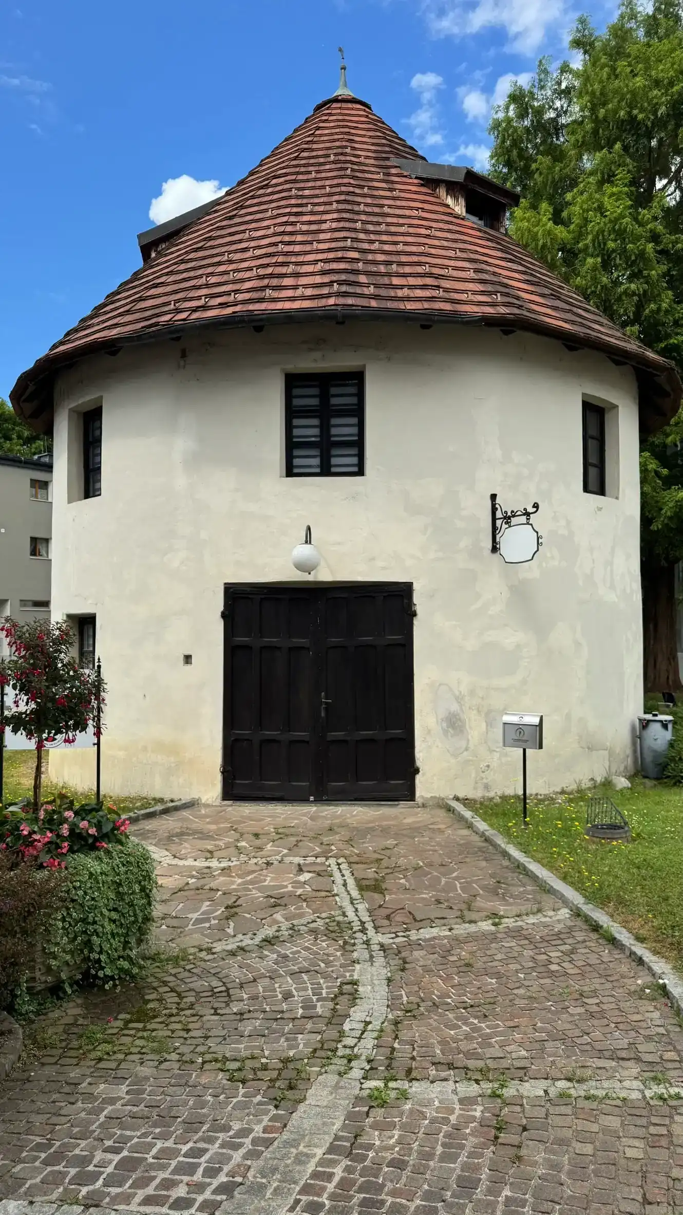 The tower has a circular wall and a conical roof.