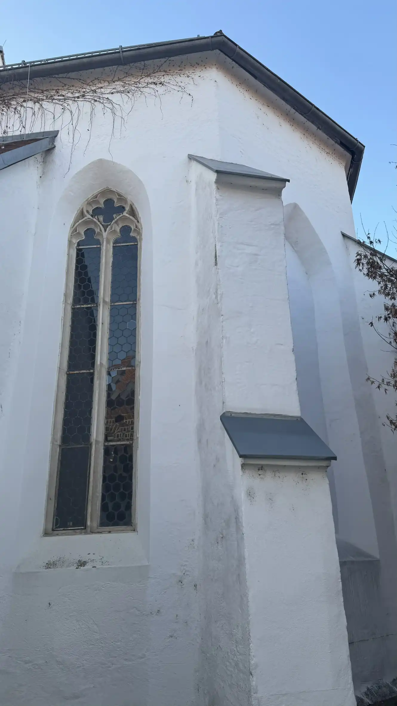 Strebepfeiler und gotisches Fenster mit Maßwerk