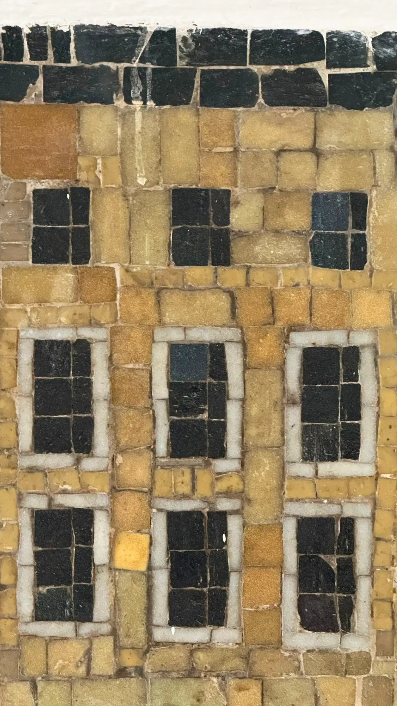 Tesserae colours: warm yellow, ochre, pearl grey, black