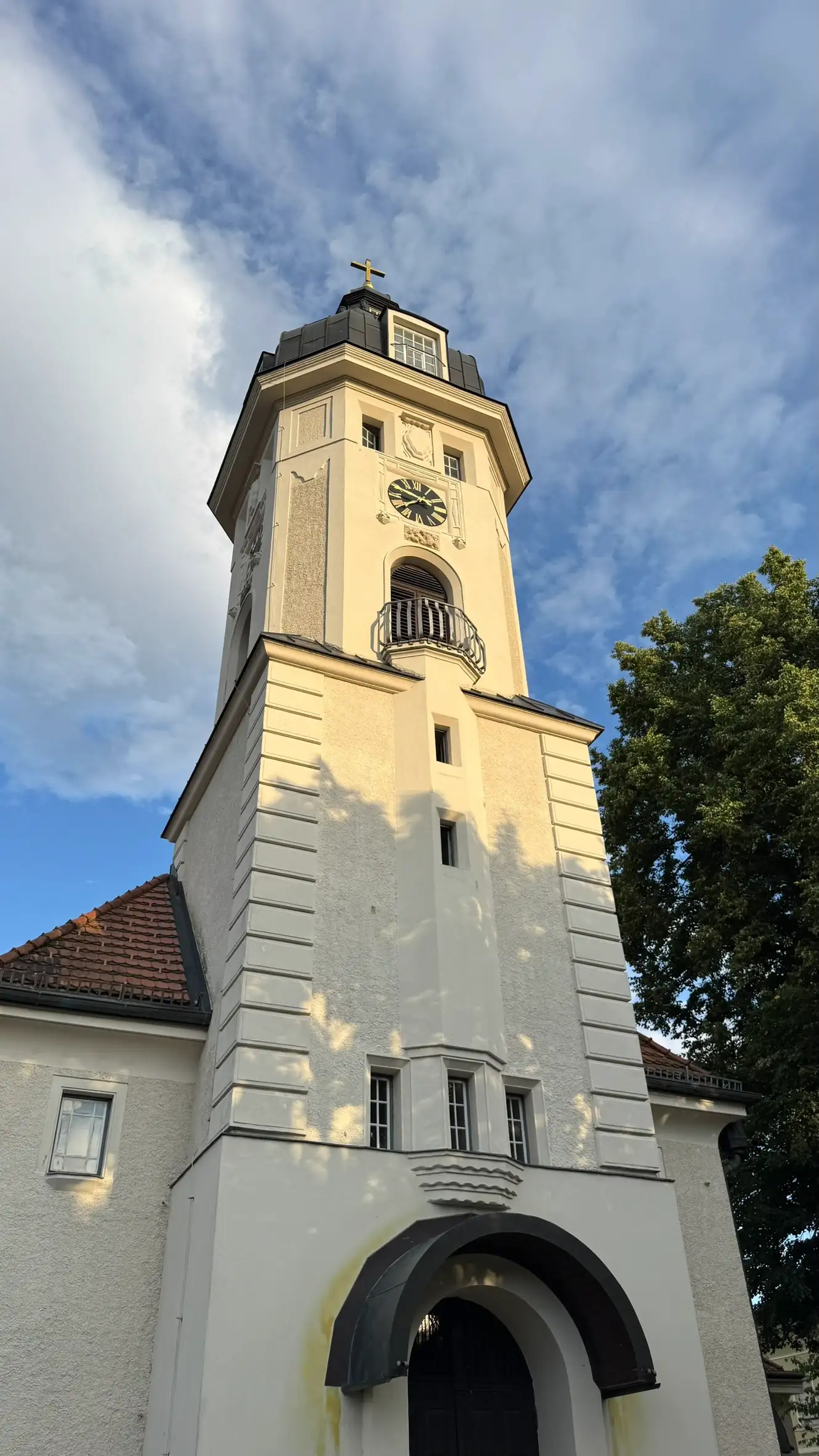 Tower’s base, mid-section, upper section and roof bathed in evening golden light