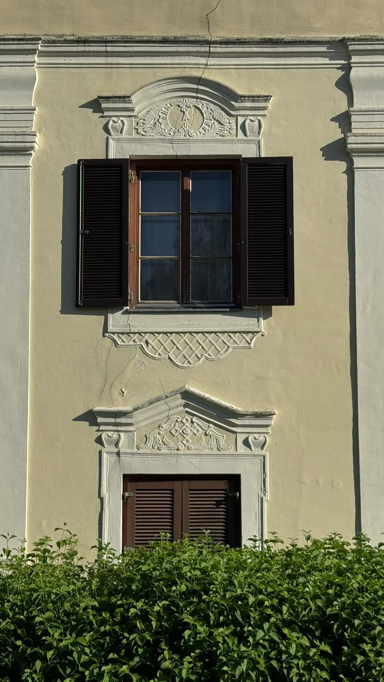 Two pilasters in view; windows with ornamented pediments