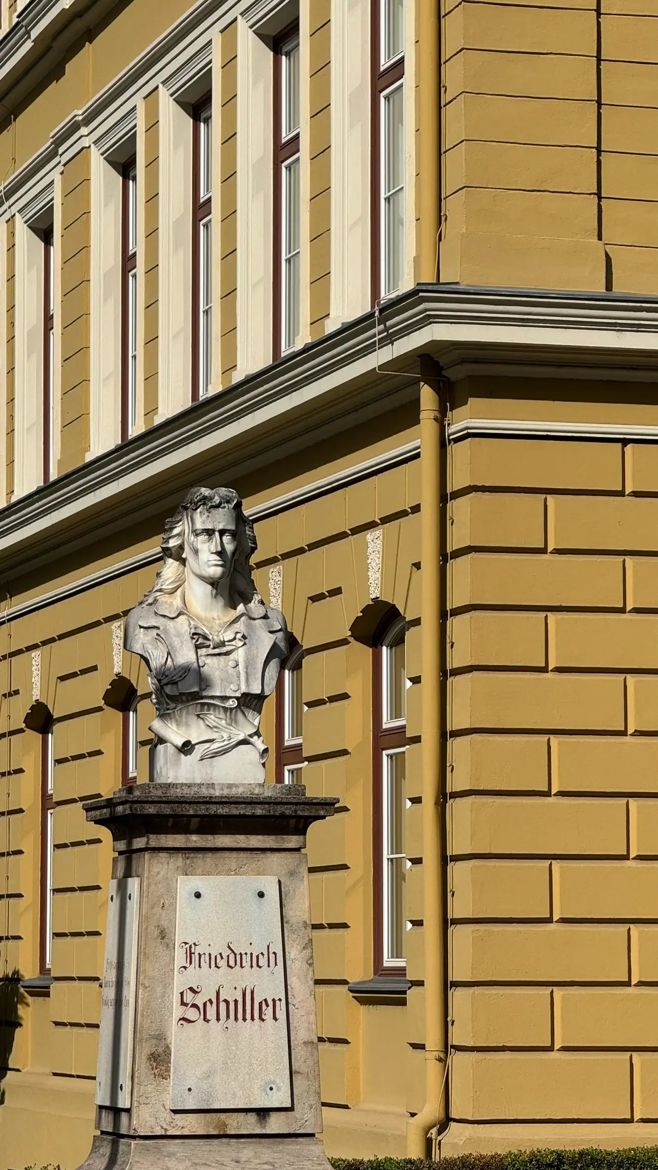Friedrich Schiller’s bust is placed next to the northwest corner of the building.