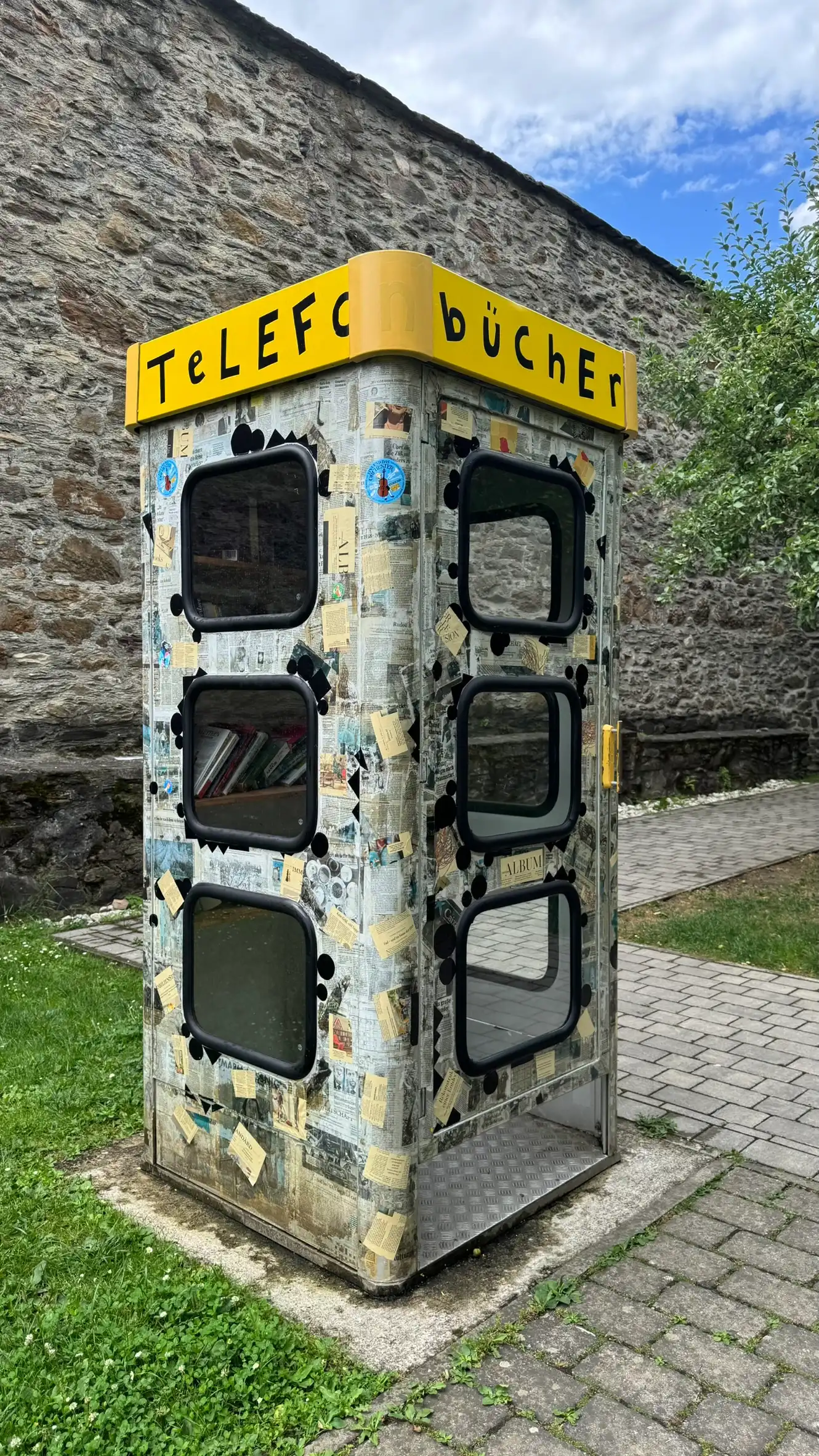 A public book kiosk is set in a repurposed telephone box.