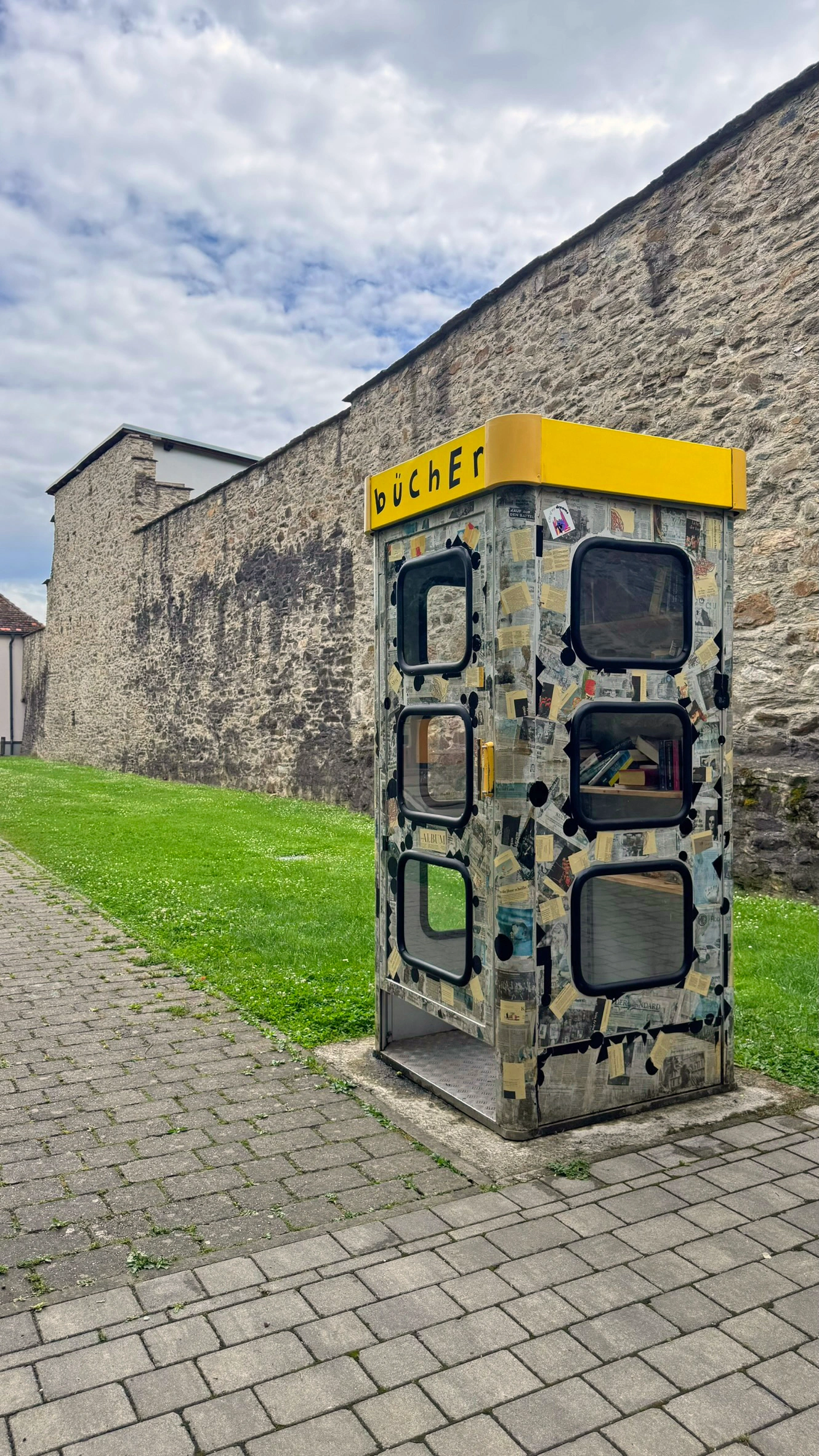 Die öffentliche Bücherbox steht neben der Stadtmauer.