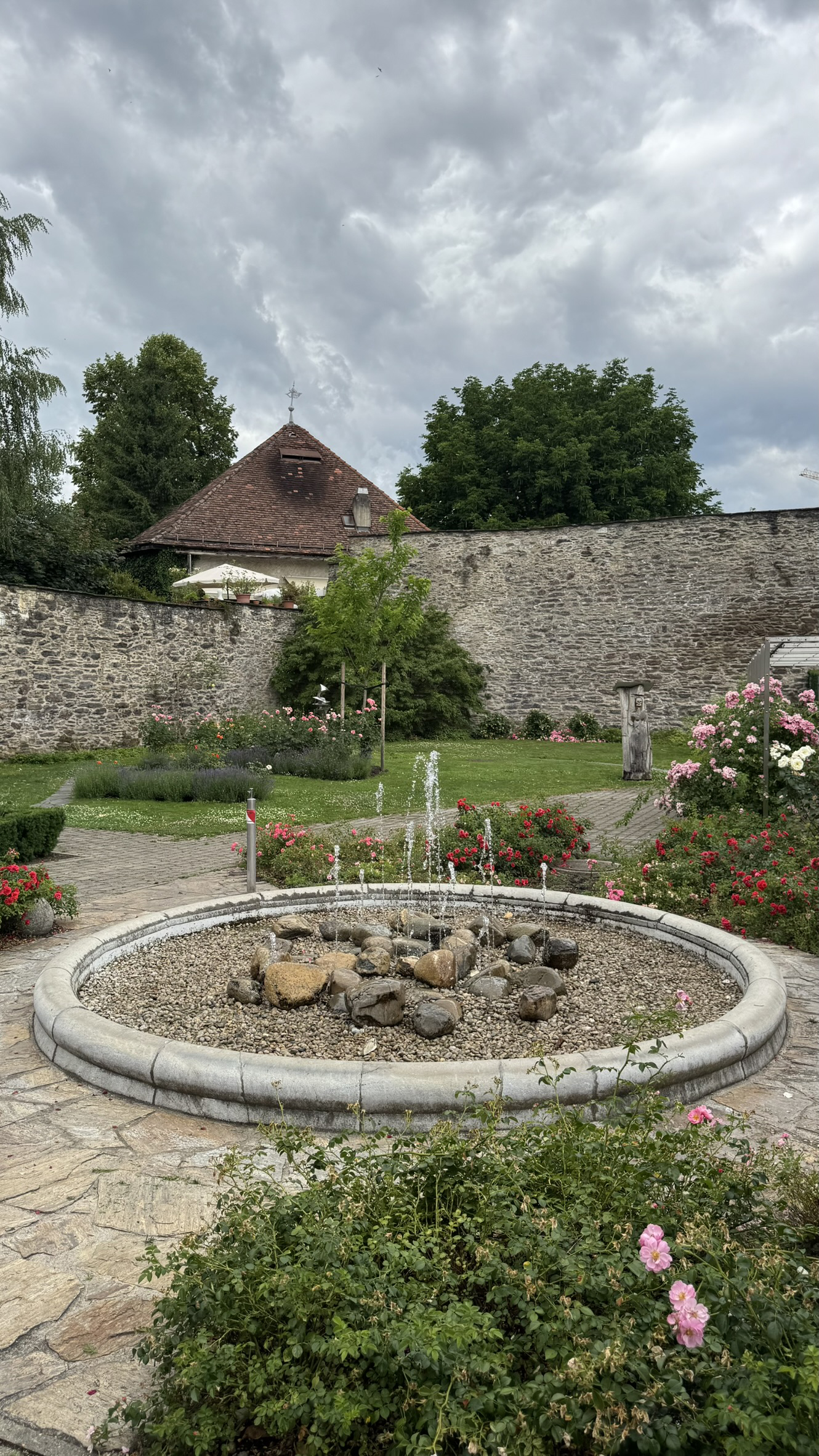 Foreground: ground-level fountain; background: bastion tower and western corner of the town wall