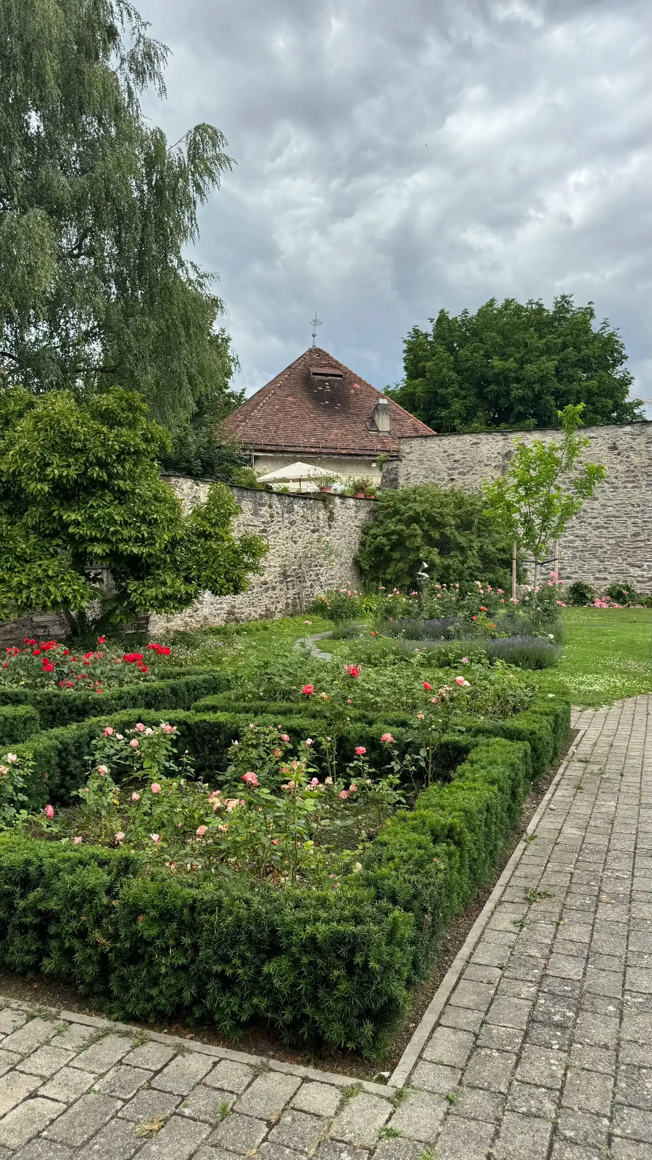 Vier Blumenbeete; Bastionsturm und westliche Ecke der Stadtmauer im Hintergrund.