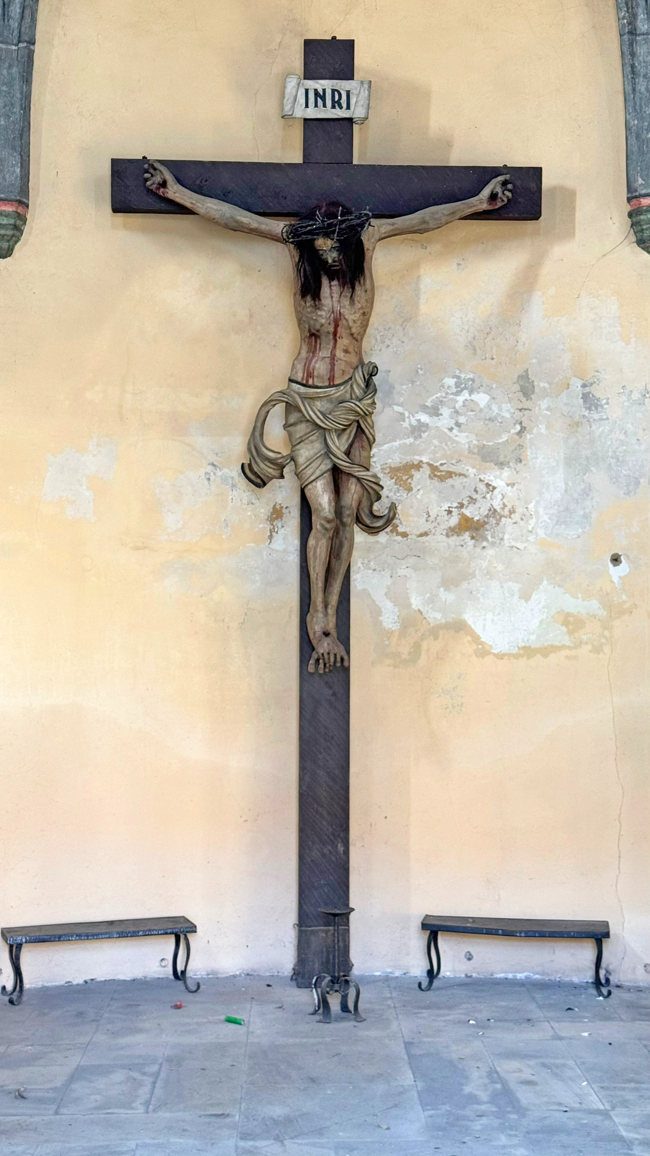 Larger-than-life crucifix at the western end of the circular wall