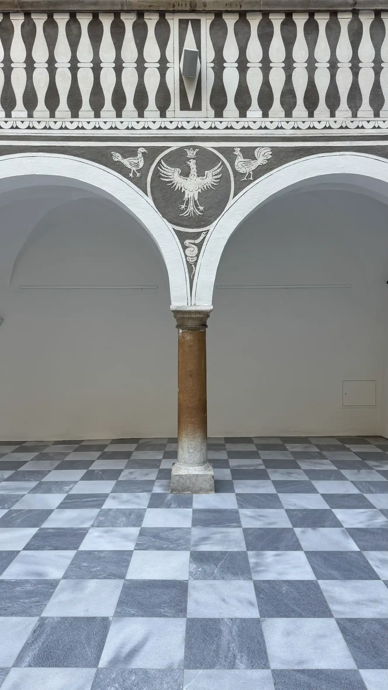 Decorative sgraffito on the balustrade and spandrel of the arcaded galleries