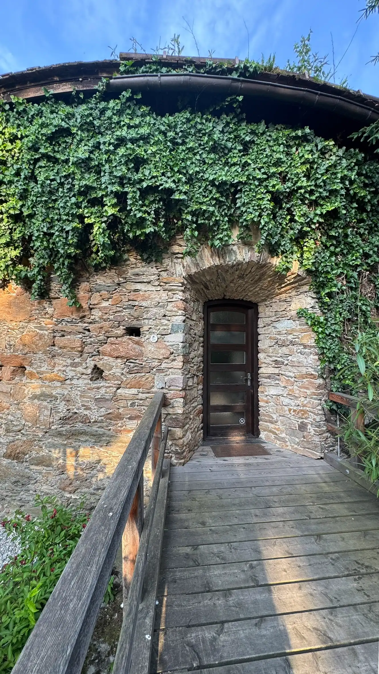 Arched doorway and bridge are absent from historical engravings, indicating they were added in modern times.