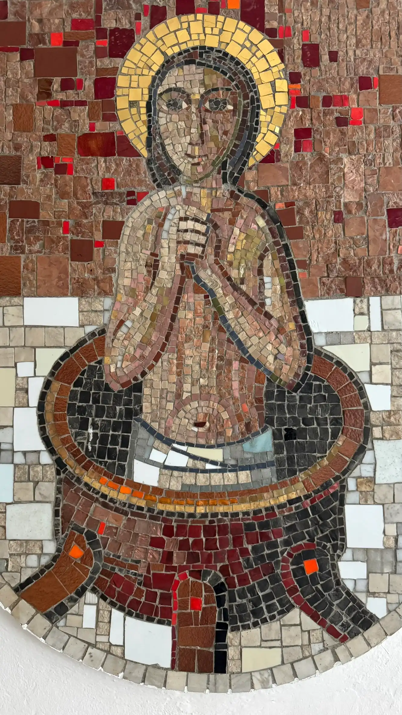 St Vitus is shown in a cauldron, symbolising the legend of his martyrdom in boiling oil.