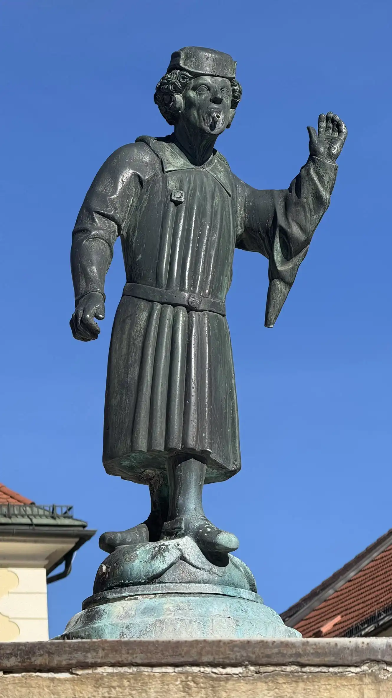 The statue probably depicts a municipal official from the late 15th century.