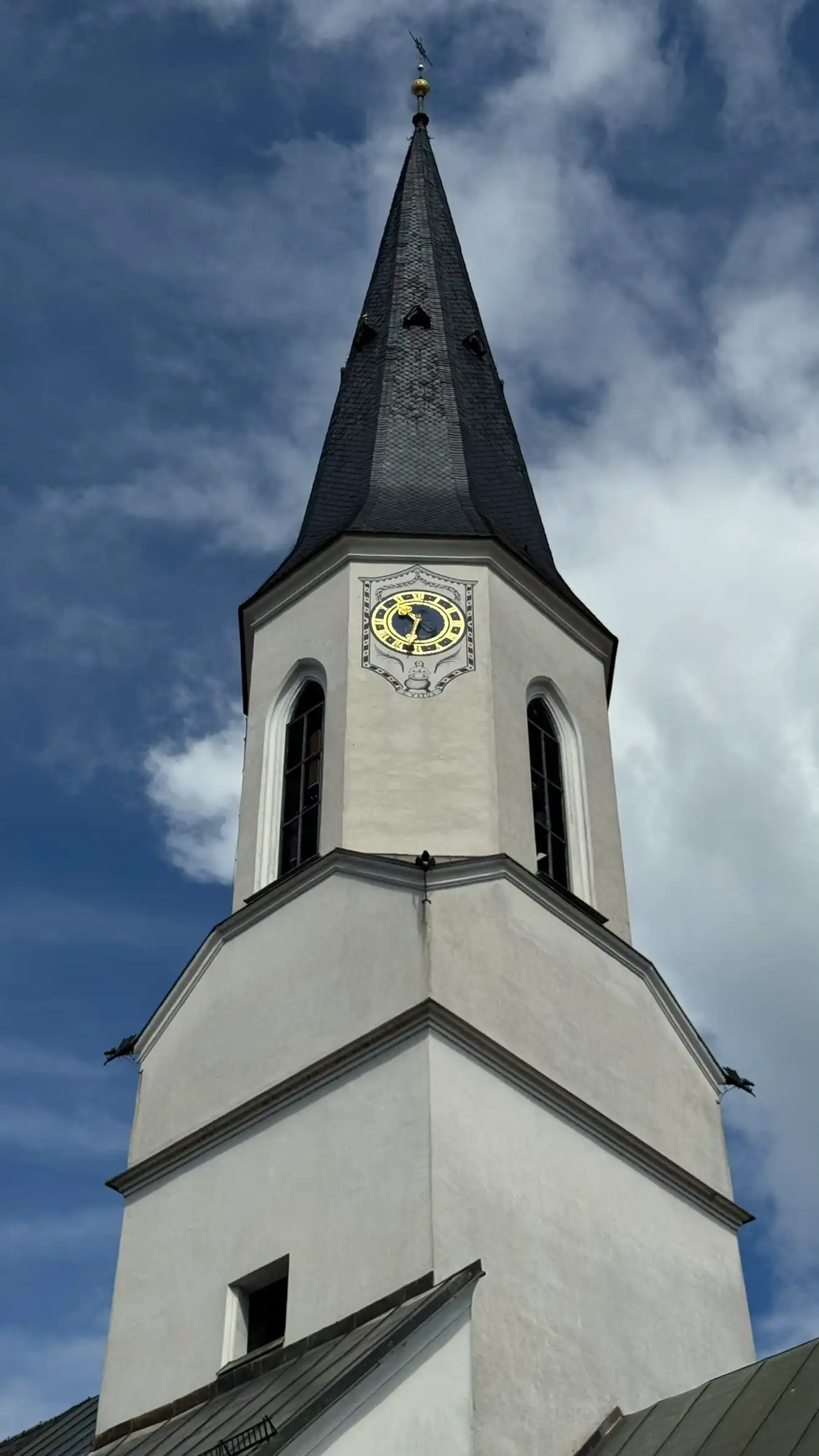 Church tower: four-sided lower section; eight-sided upper section; polygonal spire tapering to a point