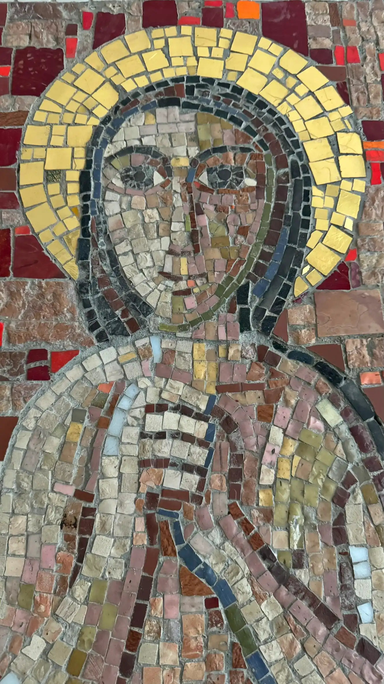 The composition is crafted with tesserae in deep reds, browns, creams, and metallic tones.