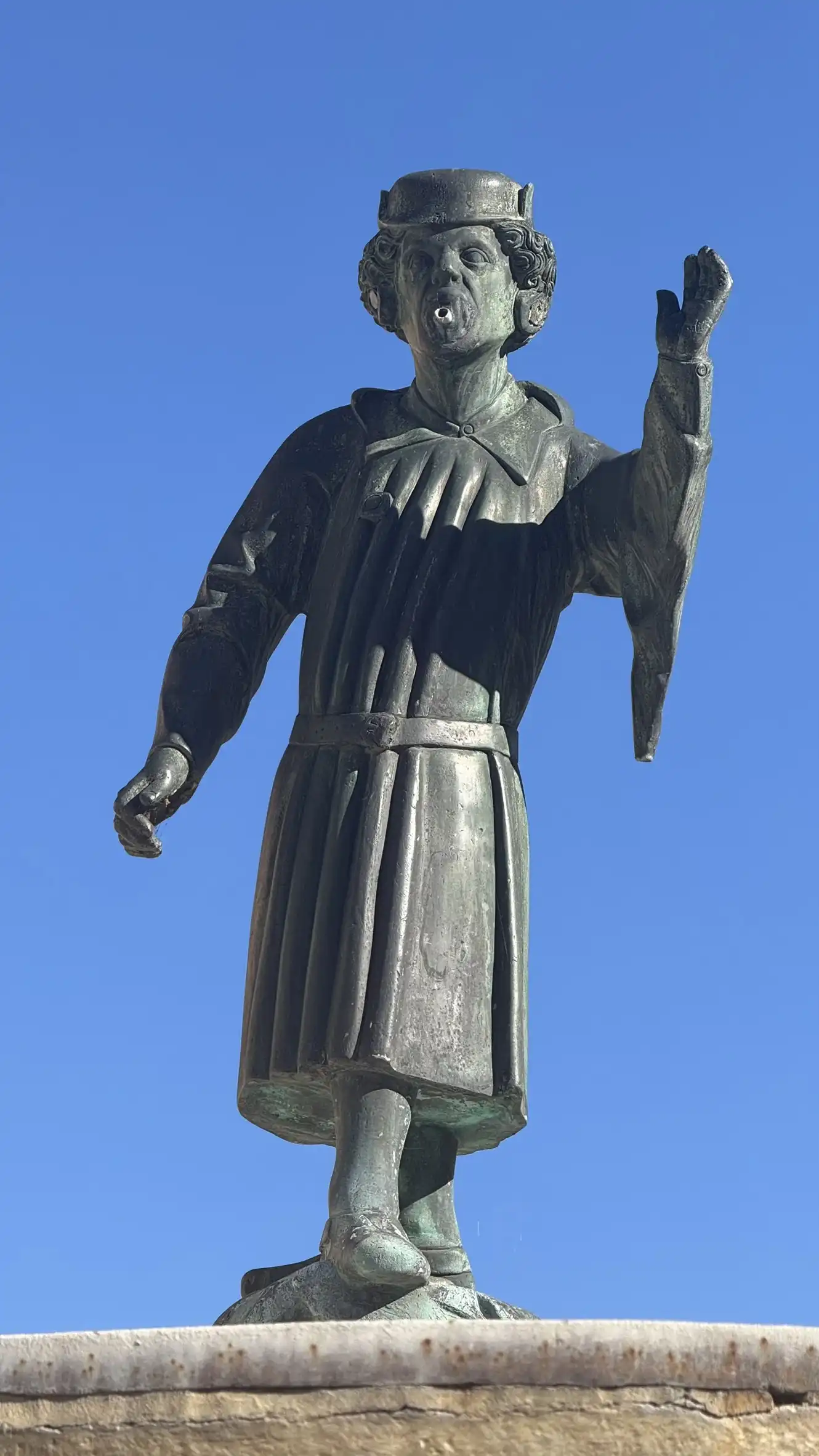 The bronze figure wears the costume and cap of miners, symbolising the importance of mining to the town.