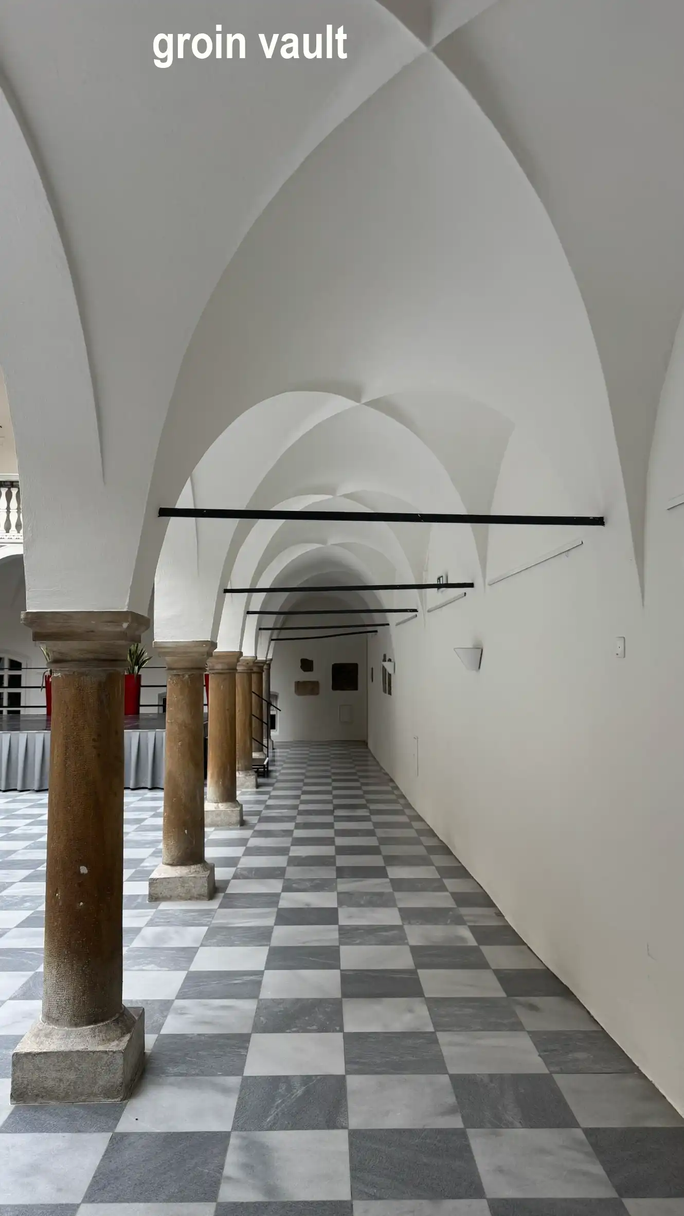 The ground-floor passage features a groin-vaulted ceiling.