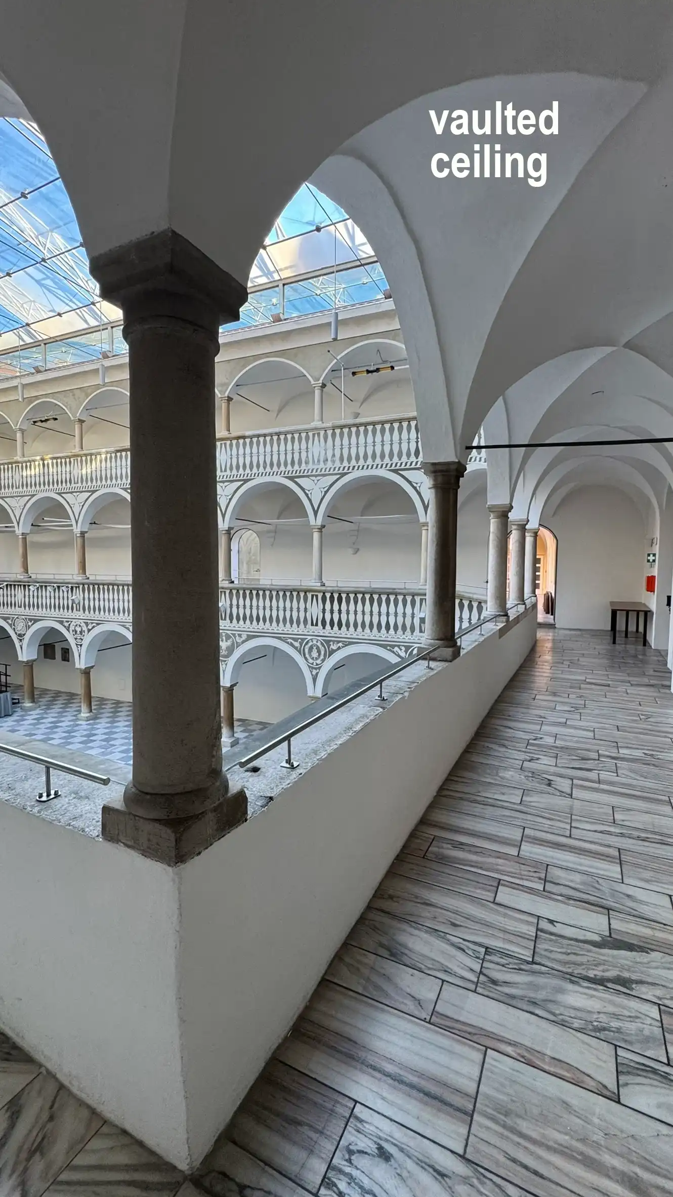 Groin vaults rest on stone columns with simple capitals.
