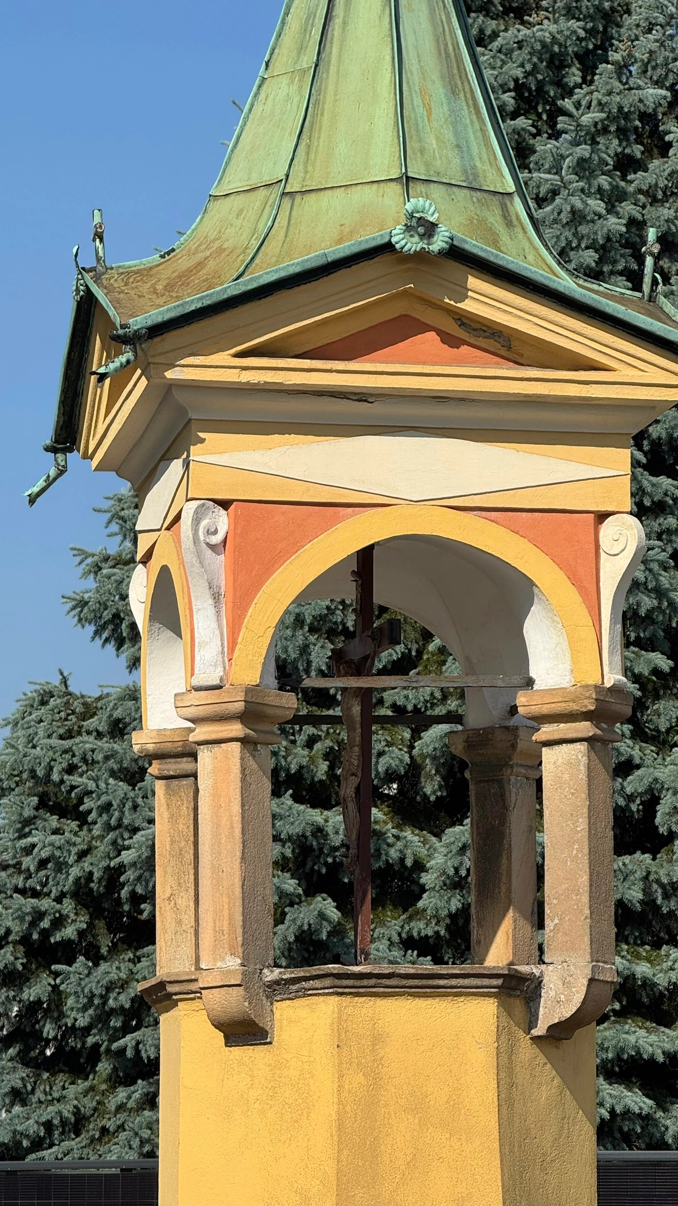A canopy-like structure, supported by four columns, rests on a tall octagonal pedestal.