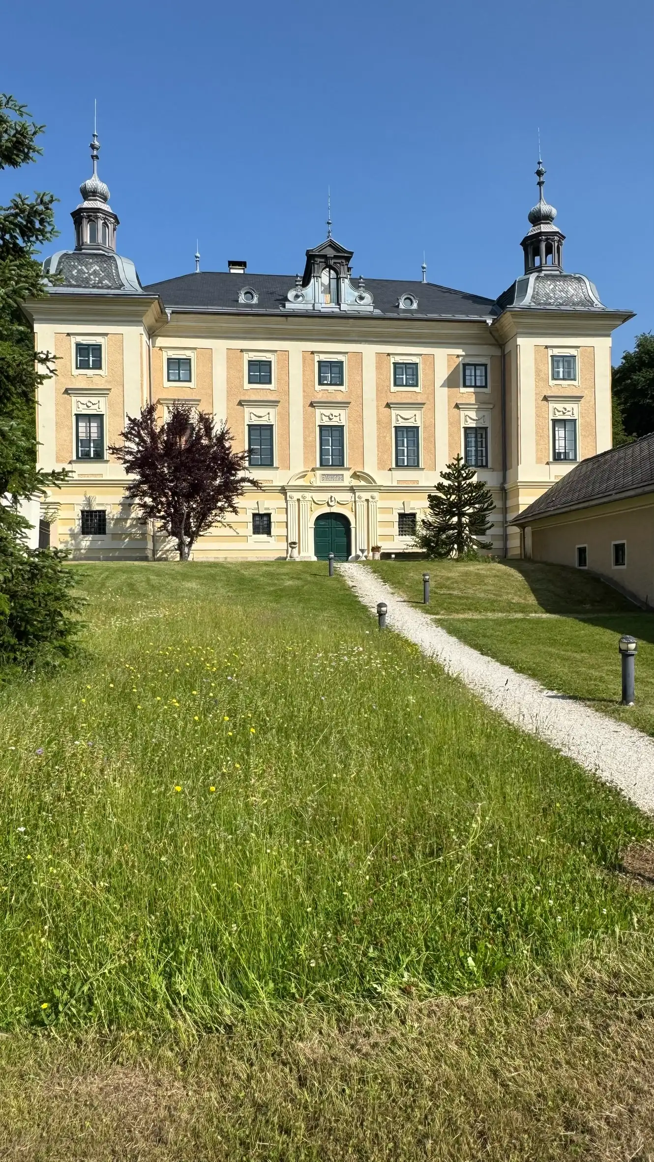 Zugang: gerader Weg, gesäumt von Rasenflächen